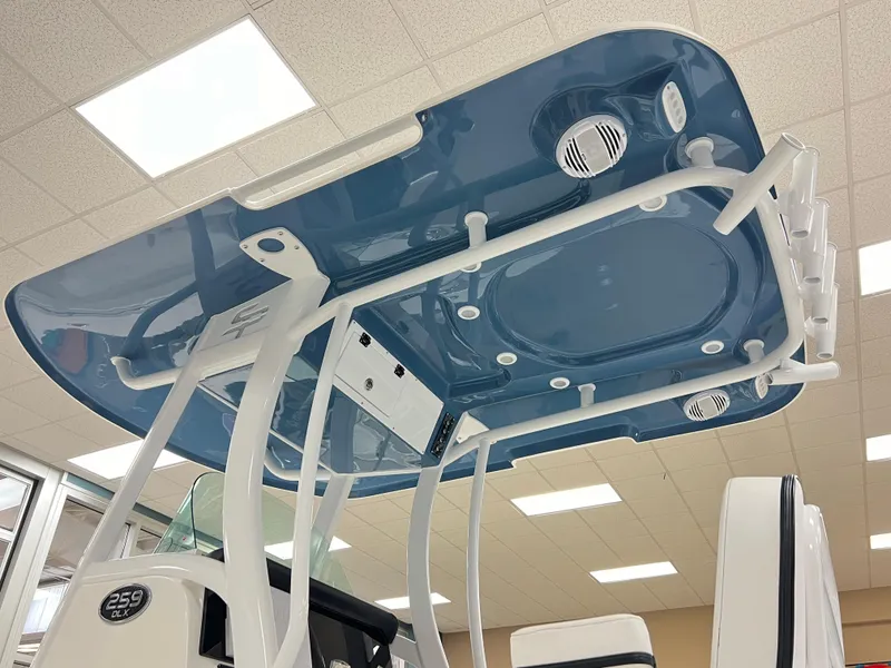 Slide: The Image of 2023 Sea Pro 259 Deep V CC boat interior with blue hardtop and speakers. - 5