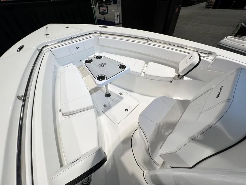 Slide: The Image of 2023 Sea Pro 259 Deep V CC boat interior with white seating and table. - 9
