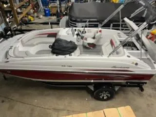 Slide: The Image of 2023 Hurricane SS188 boat in a garage, featuring red and white design. - 1
