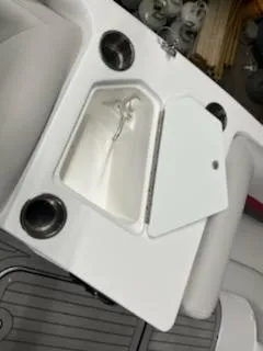 Slide: The Image of 2023 Hurricane SS188 boat with open storage compartment and cup holders. - 15