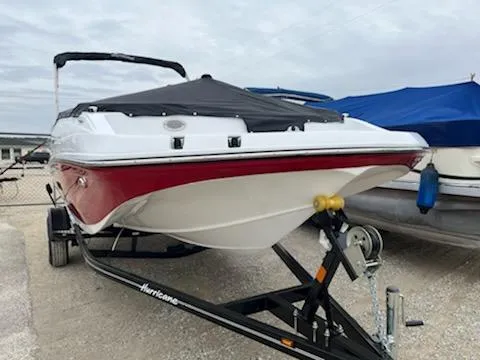 Slide: The Image of 2023 Hurricane SS188 boat on trailer, red and white hull, covered, parked outdoors. - 2