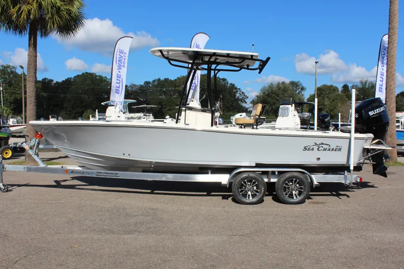 The Image of 2023 Sea Chaser 26 LX boat on a trailer, side view, outdoors. - 1