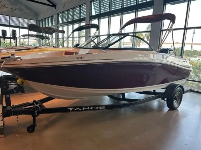 Slide: The Image of 2023 Tahoe 185 S boat on display in a showroom. - 2