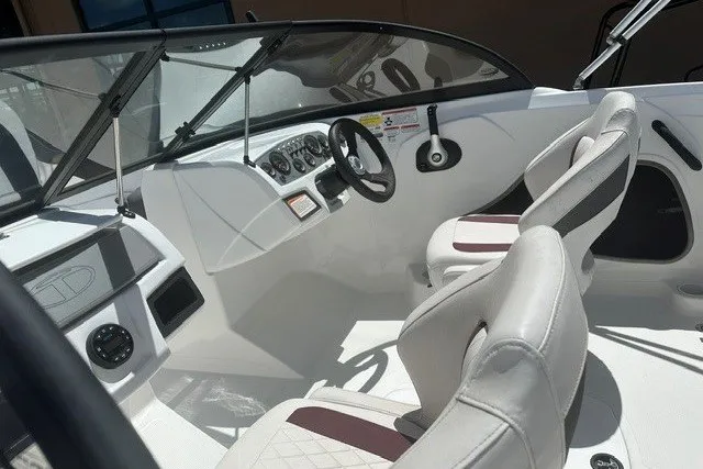 Slide: The Image of 2023 Tahoe 185 S boat interior with steering wheel and seating. - 13