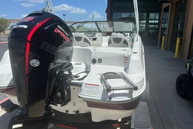 Slide: The Image of 2023 Tahoe 185 S boat with Mercury engine, docked outdoors under clear skies. - 15