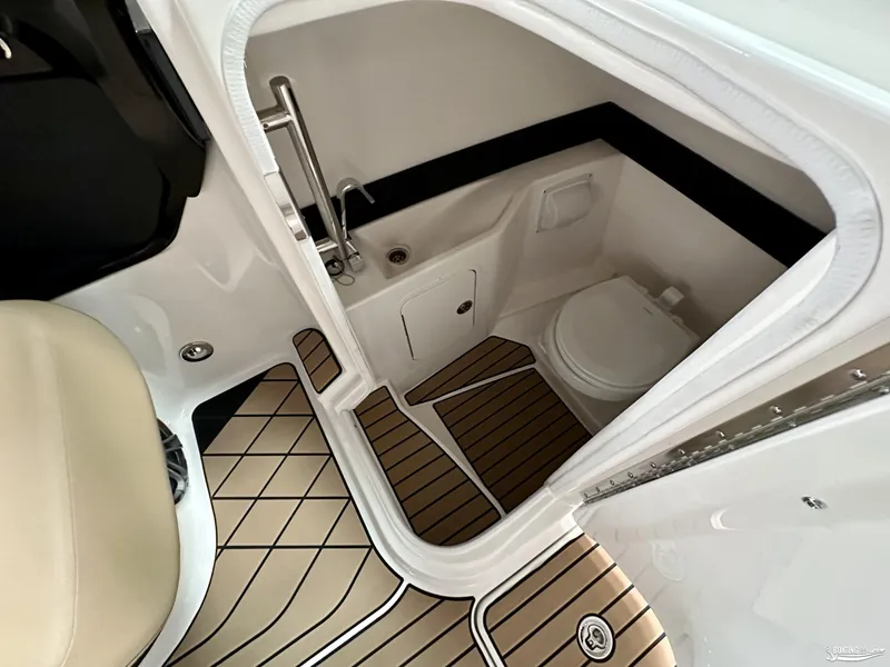 Slide: The Image of 2024 Sea Ray SLX 260 Surf boat interior with modern bathroom amenities. - 12