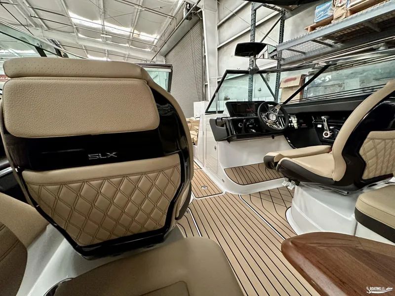 Slide: The Image of Luxurious interior of 2024 Sea Ray SLX 260 Surf boat with elegant seating and modern dashboard. - 14
