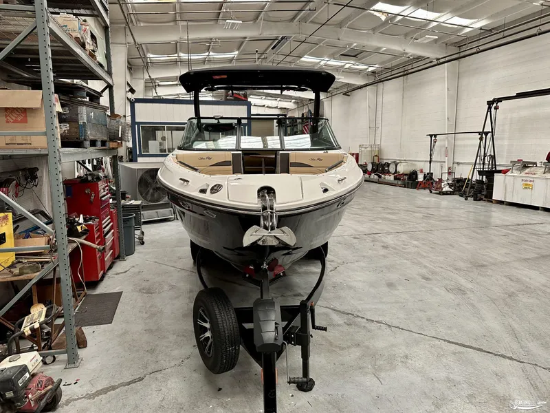 Slide: The Image of 2024 Sea Ray SLX 260 Surf boat in a spacious workshop. - 4