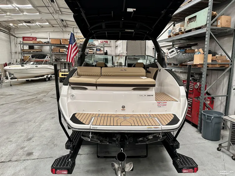 Slide: The Image of 2024 Sea Ray SLX 260 Surf boat in a workshop, rear view. - 5