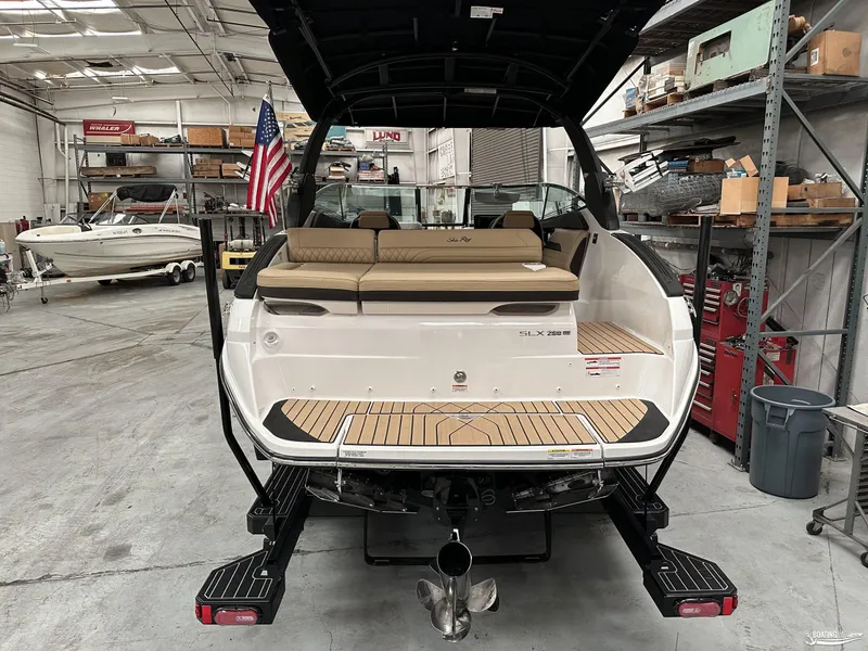 Slide: The Image of 2024 Sea Ray SLX 260 Surf boat in a workshop, rear view. - 6