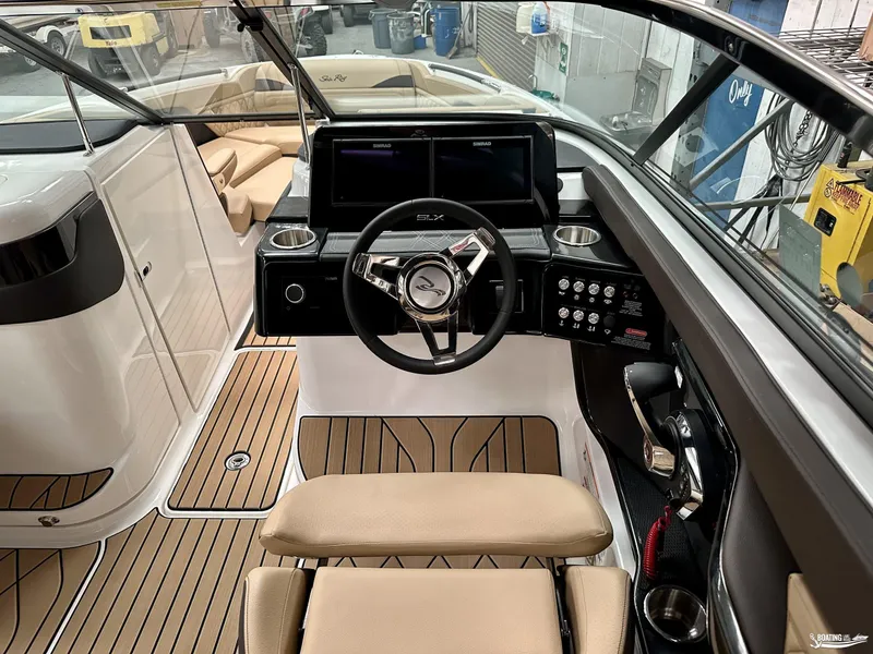 Slide: The Image of 2024 Sea Ray SLX 260 Surf boat cockpit with modern steering and controls. - 8