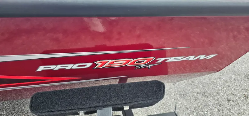 Slide: The Image of 2023 Tracker Pro Team 190 TX boat logo on red exterior. - 2