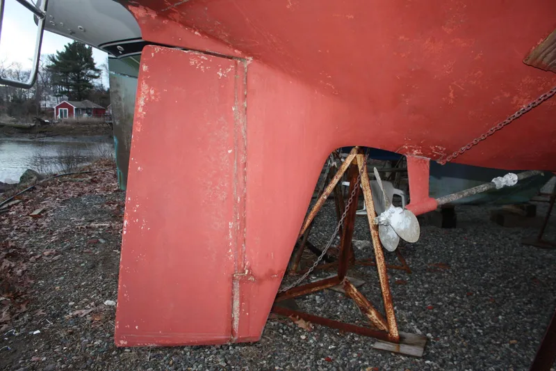 Slide: The Image of Pearson 323 sailboat keel and rudder, 1979 model, on dry dock with visible propeller. - 16
