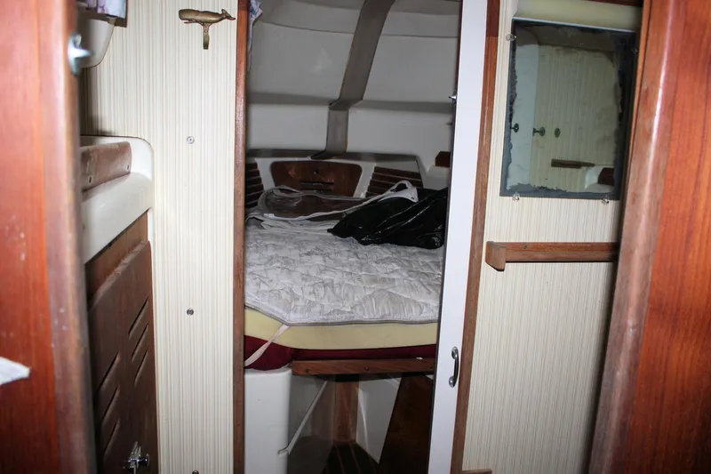 Slide: The Image of Interior cabin of a 1979 Pearson 323 sailboat with a cozy sleeping area. - 17