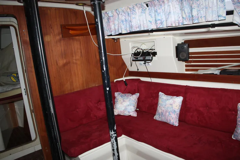 Slide: The Image of Interior of 1979 Pearson 323 sailboat with red seating and floral pillows. - 27