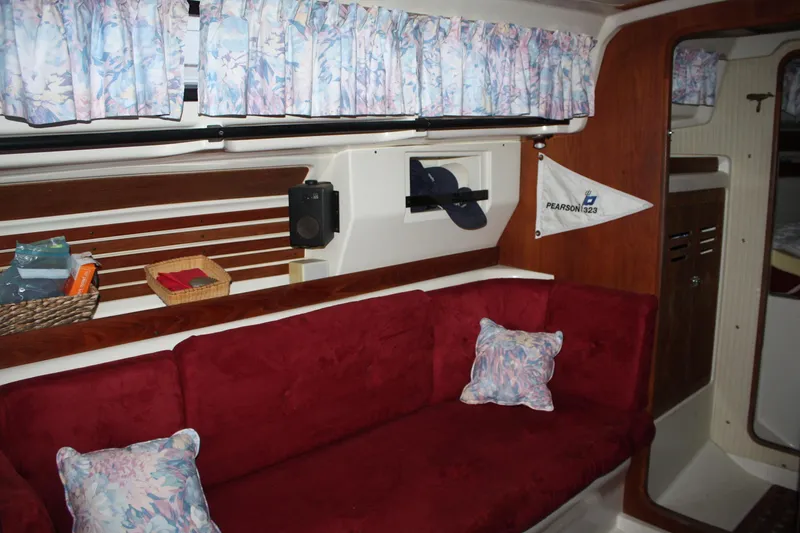 Slide: The Image of Interior of 1979 Pearson 323 sailboat with red sofa and floral curtains. - 28