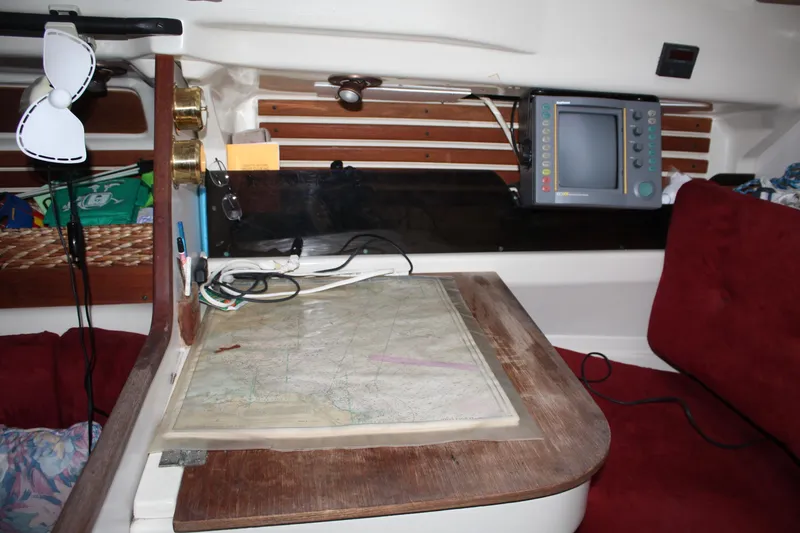 Slide: The Image of Navigation station inside a 1979 Pearson 323 sailboat with map and electronic equipment. - 30
