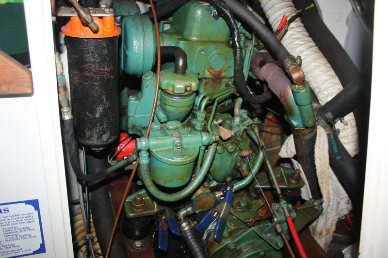 Slide: The Image of Engine compartment of a 1979 Pearson 323 sailboat, showing detailed mechanical components. - 32