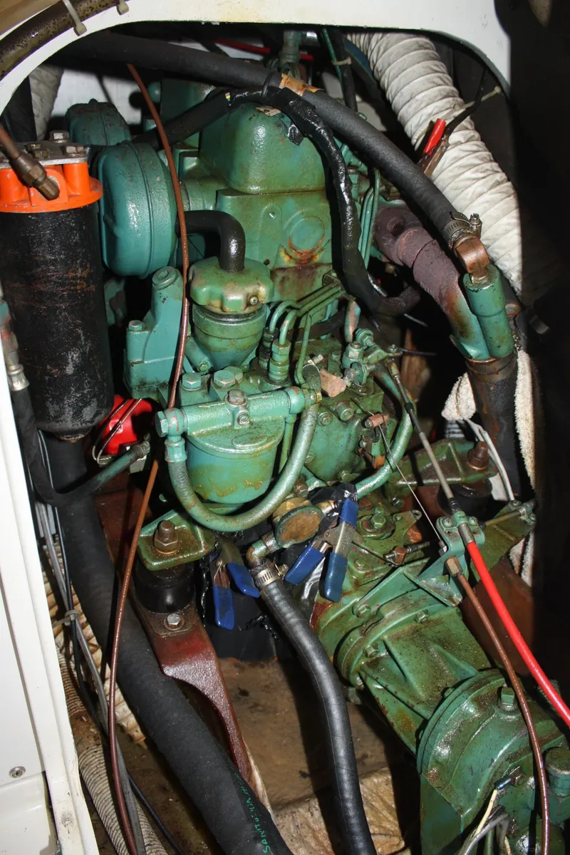 Slide: The Image of Engine compartment of a 1979 Pearson 323 sailboat, featuring various hoses and components. - 33