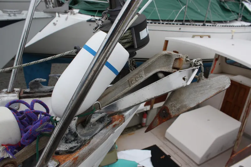 Slide: The Image of 1979 Pearson 323 sailboat anchor and deck equipment with ropes and fenders. - 8