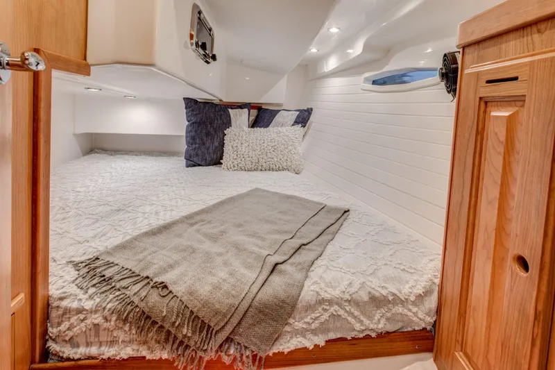 Slide: The Image of Cozy cabin bed in 2025 Tartan 365 sailboat with pillows and blanket. - 6