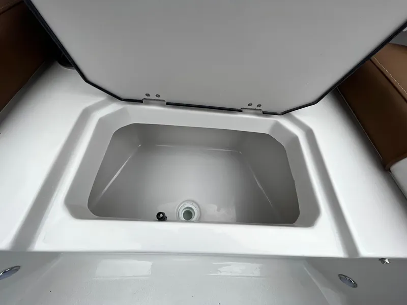Slide: The Image of 2024 Starcraft SVX 231 boat storage compartment with open lid. - 20