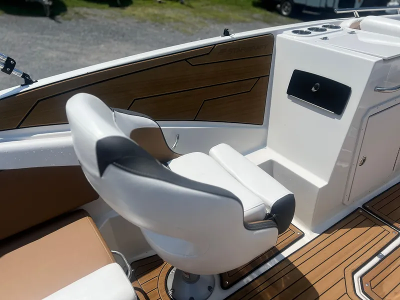 Slide: The Image of 2023 Starcraft SVX 231 OB DH boat interior with modern seating and wood accents. - 10