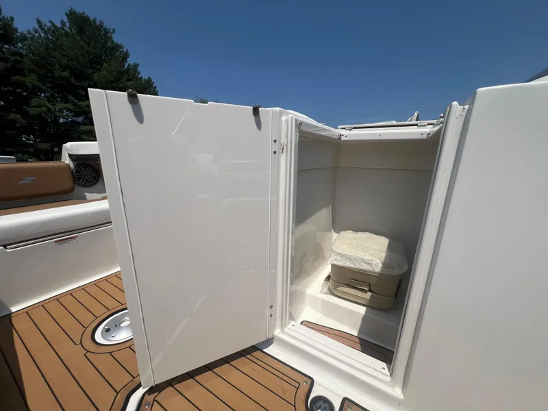 Slide: The Image of 2023 Starcraft SVX 231 OB DH boat with open storage compartment. - 12