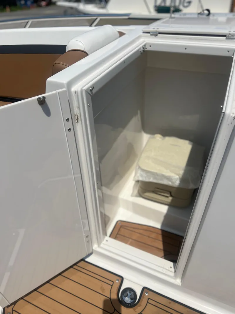 Slide: The Image of 2023 Starcraft SVX 231 OB DH boat storage compartment with wooden flooring. - 14
