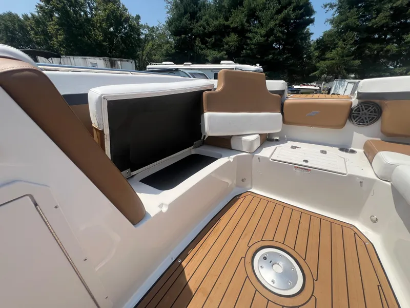 Slide: The Image of 2023 Starcraft SVX 231 OB DH boat interior with tan seating and wood-style flooring. - 16
