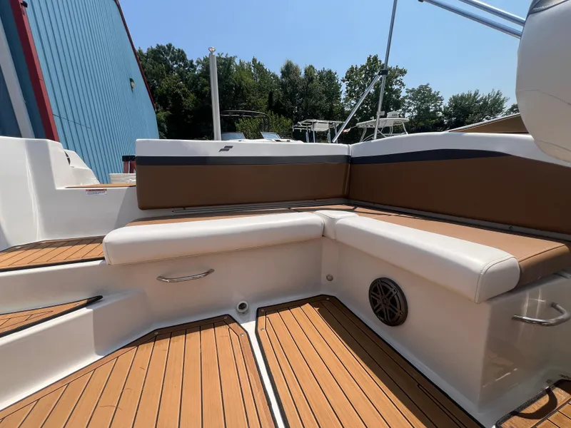 Slide: The Image of 2023 Starcraft SVX 231 OB DH boat interior with brown and white seating, wood flooring. - 17