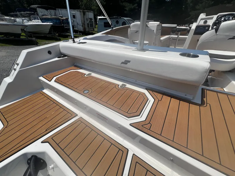 Slide: The Image of 2023 Starcraft SVX 231 OB DH boat interior with teak-style flooring and seating. - 18