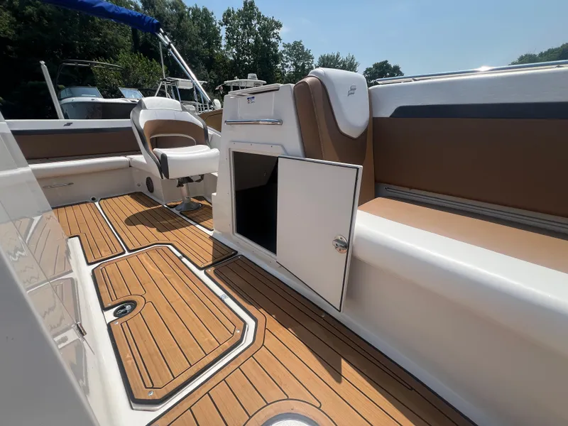 Slide: The Image of 2023 Starcraft SVX 231 OB DH boat interior with open storage, teak flooring, and seating. - 19