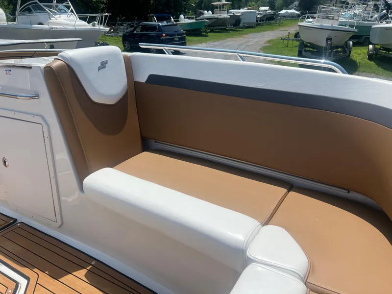 Slide: The Image of 2023 Starcraft SVX 231 OB DH boat interior with tan and white seating. - 20