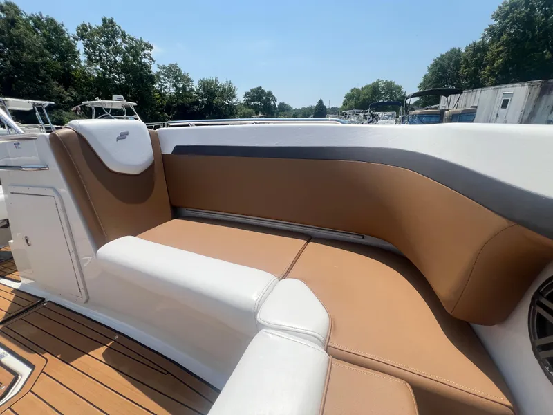Slide: The Image of 2023 Starcraft SVX 231 OB DH boat interior with tan and white seating. - 21