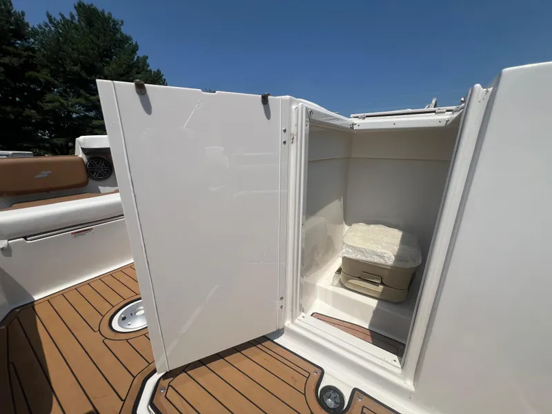 Slide: The Image of 2023 Starcraft SVX 231 OB DH boat with open storage compartment and portable toilet. - 29