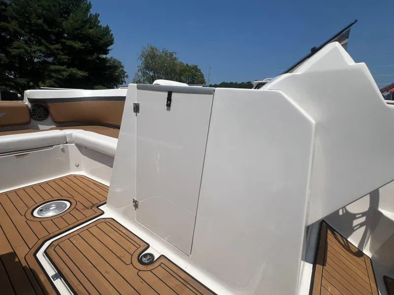Slide: The Image of 2023 Starcraft SVX 231 OB DH boat interior with teak flooring and white seating. - 31