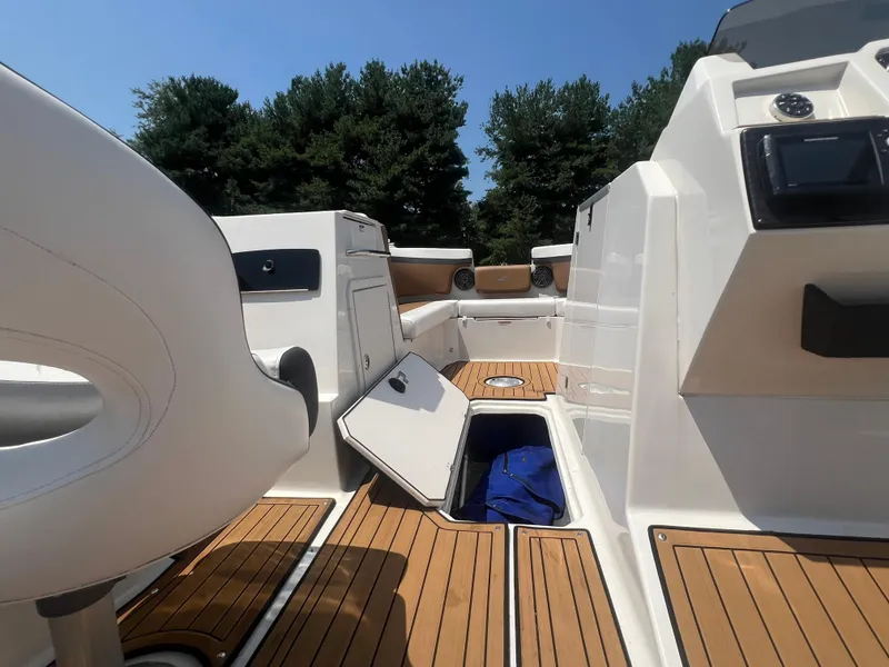 Slide: The Image of 2023 Starcraft SVX 231 OB DH boat interior with open storage compartment and seating. - 32