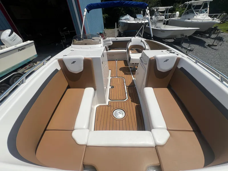 Slide: The Image of 2023 Starcraft SVX 231 OB DH boat interior with tan and white seating. - 33