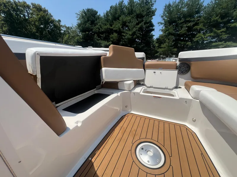 Slide: The Image of 2023 Starcraft SVX 231 OB DH boat interior with cushioned seating and wood-style flooring. - 38