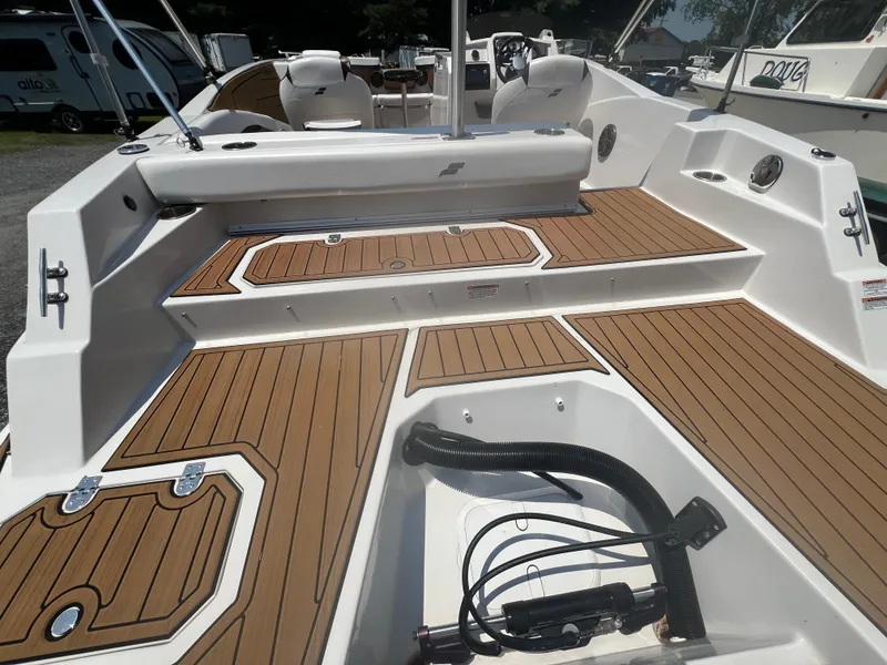 Slide: The Image of 2023 Starcraft SVX 231 OB DH boat interior with teak-style flooring and seating. - 39