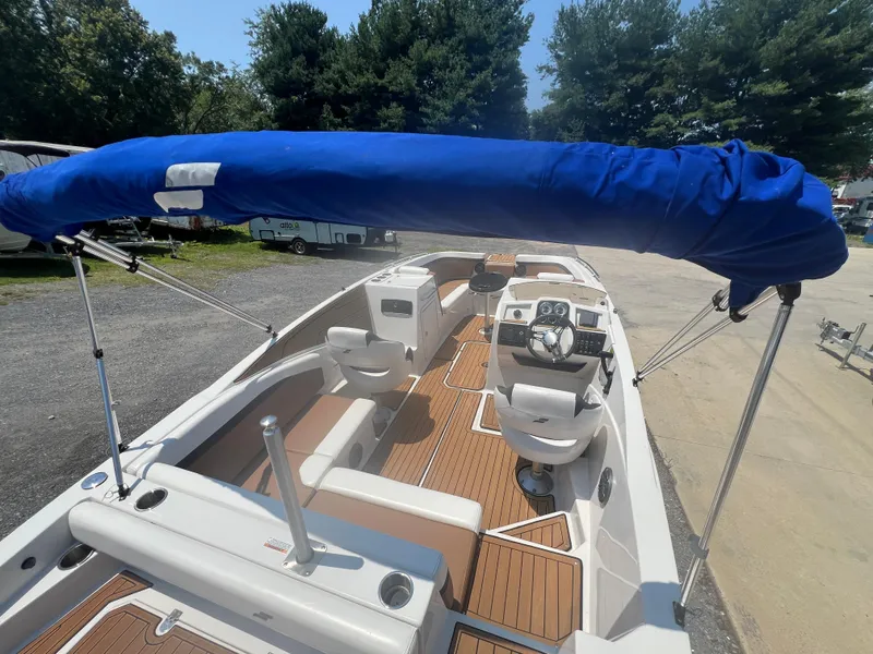 Slide: The Image of 2023 Starcraft SVX 231 OB DH boat with blue canopy and sleek interior design. - 41