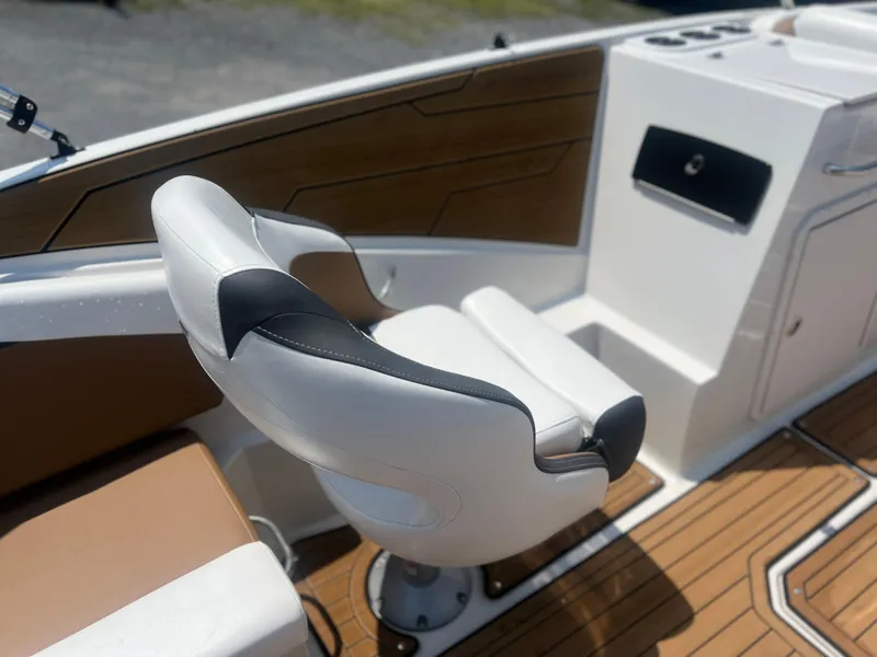 Slide: The Image of 2023 Starcraft SVX 231 OB DH boat interior with white and brown seating. - 5