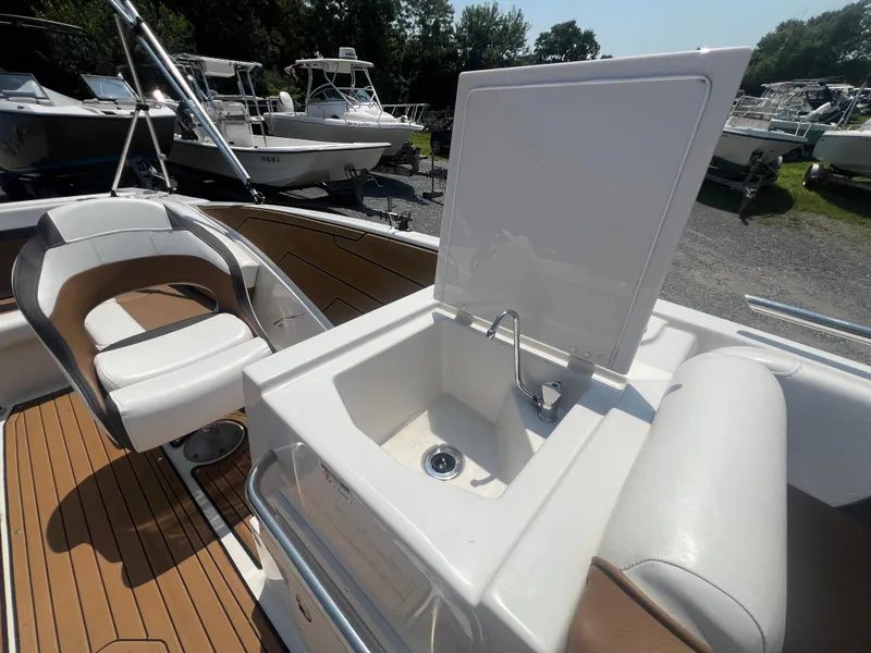 Slide: The Image of 2023 Starcraft SVX 231 OB DH boat interior with sink and seating area. - 6