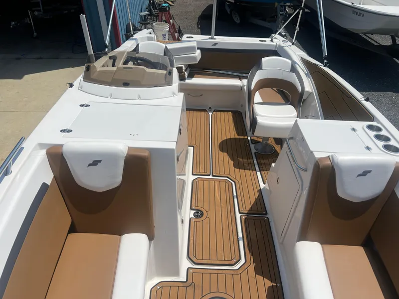 Slide: The Image of 2023 Starcraft SVX 231 OB DH boat interior with tan seating and wood-style flooring. - 8