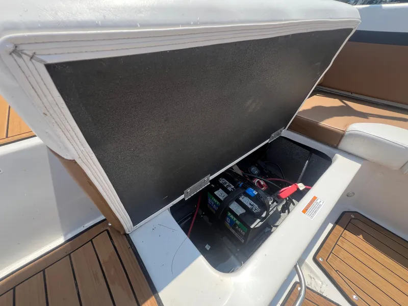 Slide: The Image of 2023 Starcraft SVX 231 OB DH boat battery compartment with open hatch. - 9