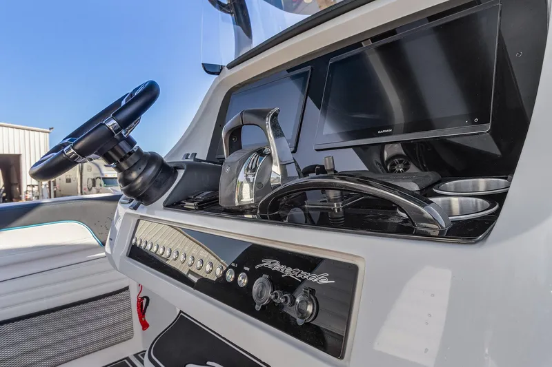 Slide: The Image of 2023 Renegade 38 Open boat dashboard with steering wheel and controls. - 16