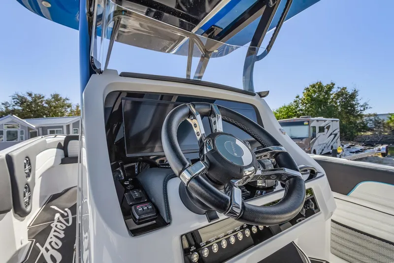 Slide: The Image of 2023 Renegade 38 Open boat steering console with modern controls and sleek design. - 19