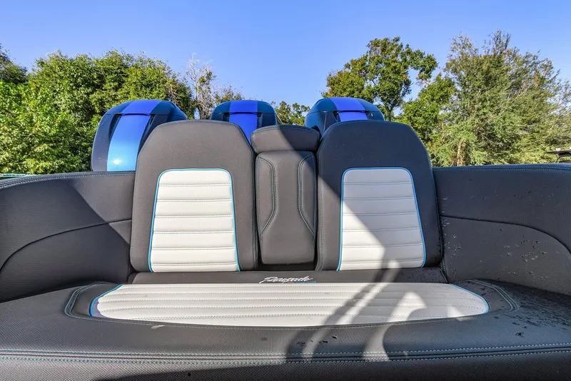 Slide: The Image of 2023 Renegade 38 Open boat seating with blue and white upholstery, outdoors. - 23