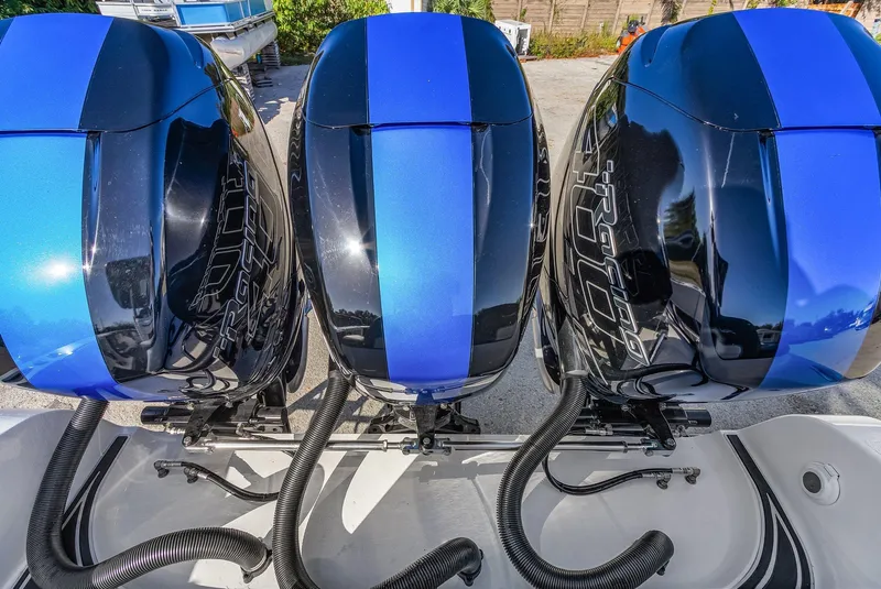 Slide: The Image of Triple outboard motors on 2023 Renegade 38 Open boat, featuring sleek blue and black design. - 26